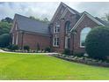 Attractive two-story brick home with a well-kept lawn and garden bed at 6553 Vintage Ridge Ln, Fuquay Varina, NC 27526