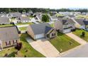 Aerial view of a home featuring a driveway and lawn in a neighborhood with similar homes at 6920 Moss Creek Way, Rocky Mount, NC 27804