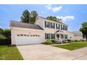 Lovely two-story home with an attached garage and well-kept lawn and garden at 6924 Coventry Ridge Rd, Raleigh, NC 27616
