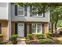 Inviting townhome with brick and siding, featuring well-maintained landscaping and a cozy entrance at 7731 Kingsberry Ct, Raleigh, NC 27615