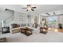 Spacious living room with comfortable seating, a ceiling fan, and easy access to the dining area at 9300 Lake Wheeler Rd, Fuquay Varina, NC 27526