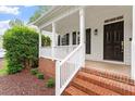 Close-up of the front porch with brick accents and a white railing at 9425 Brimstone Ln, Raleigh, NC 27613