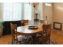 Traditional dining room with hardwood floors, wooden furniture set, chandelier, and lots of natural light at 100 Sheraton Ln, Garner, NC 27529