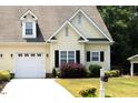 Charming home featuring an attached garage, well-maintained lawn, and complemented by established landscaping at 100 Sheraton Ln, Garner, NC 27529
