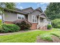 Charming front exterior featuring mature landscaping, healthy green lawn, and a private front entry at 11005 Louson Pl, Raleigh, NC 27614