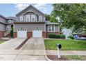 Charming two-story home featuring a two-car garage, mature landscaping, and a well-maintained lawn at 11005 Louson Pl, Raleigh, NC 27614