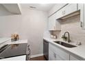 Modern kitchen with white cabinets, stainless steel appliances, quartz countertops, and tiled backsplash at 118 Rhum Pl, Garner, NC 27529
