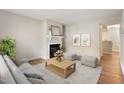 Bright living room featuring a fireplace, hardwood floors, and neutral colors at 118 Rhum Pl, Garner, NC 27529