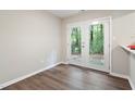 Bright room featuring French doors that open to a backyard space; hardwood flooring at 118 Rhum Pl, Garner, NC 27529
