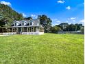 Lovely home with a welcoming porch, expansive lawn, and a storage shed at 1283 Ennis Rd, Angier, NC 27501