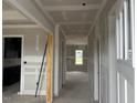 Hallway with white trim and view of a window at the end of the hall, and a doorway to the left at 129 Retreat Run, Smithfield, NC 27577