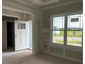 Bright room featuring a large window providing lots of natural light, wainscoting, and an open doorway at 129 Retreat Run, Smithfield, NC 27577