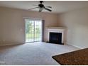 Spacious living room featuring a fireplace, sliding glass doors to the backyard and a ceiling fan at 1304 Cozart St # 119, Durham, NC 27704
