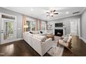 Spacious living room featuring a fireplace, hardwood floors, and large windows at 1324 Sandybrook Ln, Wake Forest, NC 27587