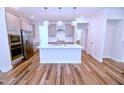 Bright kitchen with stainless steel appliances, white countertops, subway tile backsplash, and modern pendant lighting at 1441 Rosepine Dr Dr, Cary, NC 27519