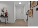 Bright entryway with neutral walls, console table, and decorative mirror and artwork at 1536 Maybrook Dr, Raleigh, NC 27610