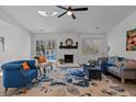Inviting living room featuring a fireplace, ceiling fan, and access to a deck with outdoor seating at 1536 Maybrook Dr, Raleigh, NC 27610