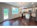 Eat-in kitchen features an island, stainless steel appliances, and an adjacent deck access at 1746 Hammocks Beach Trl, Apex, NC 27502