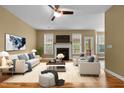 Spacious living room with a fireplace, ceiling fan, neutral-colored furniture, and ample natural light at 2067 Glenkirk Dr, Burlington, NC 27215