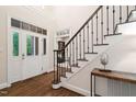 Elegant foyer with hardwood floors, staircase with iron railings, and a view of the study at 209 Bailey Ridge Dr, Morrisville, NC 27560