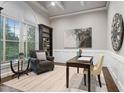 Cozy study with built-in shelves, wainscoting, and a large arched window at 209 Bailey Ridge Dr, Morrisville, NC 27560