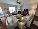 Bright and inviting living room with plush seating, dark wood floors and a cozy fireplace at 2535 Kinglass Dr, Fuquay Varina, NC 27526