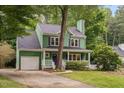 Two-story green home with a front-facing garage and a purple front door at 2724 Glastonbury Rd, Apex, NC 27539