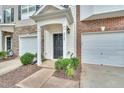 Inviting front entrance features a black door, manicured bushes, and a well-maintained lawn at 3027 Courtney Creek Blvd, Durham, NC 27713