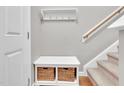 Functional entryway features storage bench with baskets, coat rack, and staircase, blending style with convenience at 3027 Courtney Creek Blvd, Durham, NC 27713