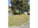 Tranquil backyard with mature trees and a storage shed adjacent to the house at 304 Sandalwood Ave, Louisburg, NC 27549