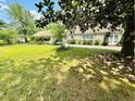 Inviting one-story home with a cozy front yard with mature trees and shrubs at 304 Sandalwood Ave, Louisburg, NC 27549