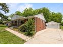 A beautiful home with a detached garage, a well-manicured lawn, and lovely landscaping at 305 Oakgrove Dr, Graham, NC 27253