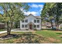 Beautiful two-story home showcasing board and batten siding, stone accents, and a well-manicured lawn at 305 W Canary St, Dunn, NC 28334