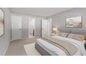Neutral bedroom with ensuite bathroom, plush bed and natural light at 3088 Colony Rd # A, Durham, NC 27705