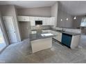 Kitchen with white cabinets, granite countertops and modern appliances, ready for finishing touches at 311 W Market St, Graham, NC 27253