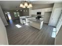 Bright, open floor plan with modern kitchen featuring stainless steel appliances and granite countertops at 311 W Market St, Graham, NC 27253