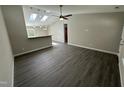Contemporary living room showcasing a seamless layout, wood flooring, and skylights at 311 W Market St, Graham, NC 27253