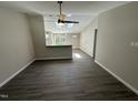 Open-concept living room featuring wood-look floors and plenty of natural light at 311 W Market St, Graham, NC 27253