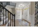 Spacious foyer with hardwood floors, white trim, and elegant double doors at 3124 Briar Stream Run, Raleigh, NC 27612