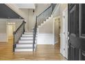 Bright foyer with hardwood floors, a staircase with iron railings, and ample natural light at 3124 Briar Stream Run, Raleigh, NC 27612