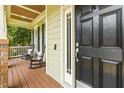 Inviting front porch with rocking chairs and a beautifully crafted black front door at 3124 Briar Stream Run, Raleigh, NC 27612
