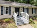 Inviting front porch with white railing and black door; stylish exterior at 3600 Star Trek Ct, Raleigh, NC 27604