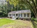 Charming single story home with black shutters surrounded by a forest landscape at 3600 Star Trek Ct, Raleigh, NC 27604