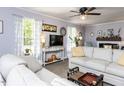 Cozy living room with neutral tones, a ceiling fan, and great natural light at 3600 Star Trek Ct, Raleigh, NC 27604