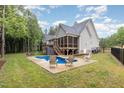 Inviting backyard features a swimming pool, screened porch, and ample seating for outdoor enjoyment at 40 Yellowstone Ct, Youngsville, NC 27596