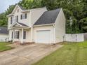 Charming two-story home with an attached garage and a manicured lawn, providing a welcoming curb appeal at 4020 Mindspring Dr, Raleigh, NC 27610