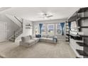 Spacious living room features a comfortable sectional sofa, ceiling fan, and plenty of natural light at 409 Rhamkatte Rd, Holly Springs, NC 27540