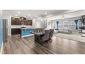 Open-concept living space featuring modern finishes, wood floors, and seamless flow between the rooms at 409 Rhamkatte Rd, Holly Springs, NC 27540