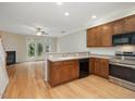 Open kitchen boasts stainless steel appliances, hardwood floors, and great natural light at 4719 Altha St, Raleigh, NC 27606