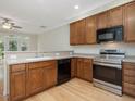Bright kitchen featuring stainless steel appliances, wood cabinets, and hardwood flooring at 4719 Altha St, Raleigh, NC 27606